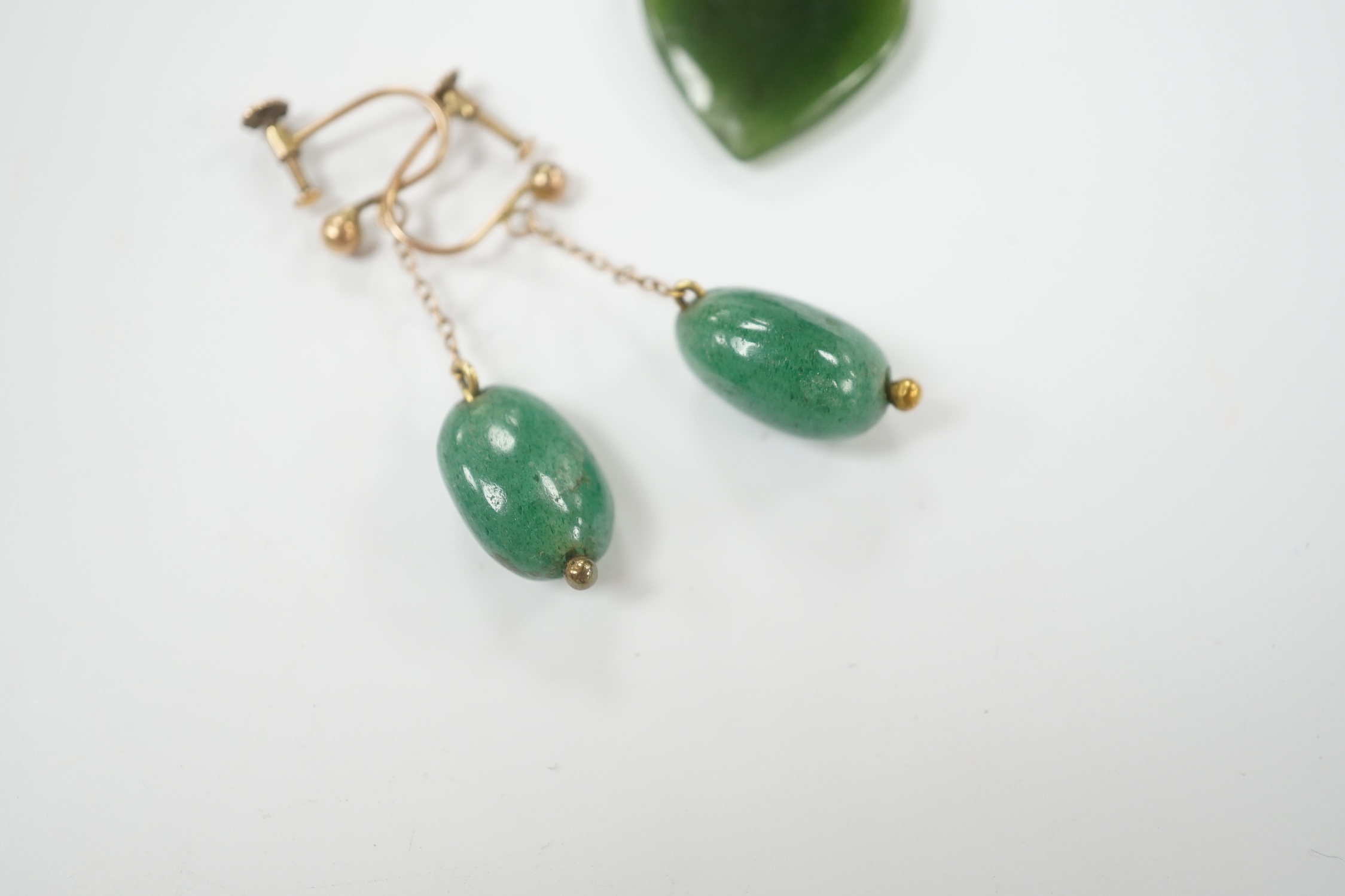 A gilt metal mounted nephrite heart shape pendant, 20mm and a pair of simulated jade earrings.